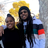 Marcus Angelo Bryant stands to the right of his mother, Theresa Thompson, with his right arm around her shoulders while both smile and stand next to a tree on a sunny day