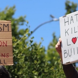writing classes sf Protestors holding up anti-rascism signs