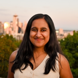 Geetanshi Sharma, in front of a city scape