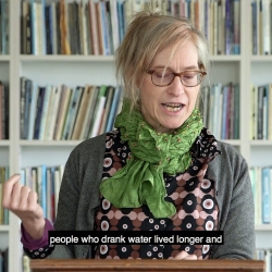 Nona Caspers reading from her book, the 5th Woman, in colorful clothing